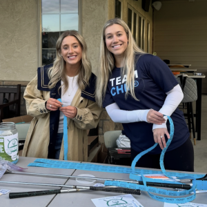 Two women managing the raffle ticket table at a fundraising event for the Choroideremia Research Foundation (CRF).