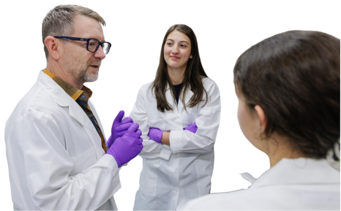 Fourth-year student Grace Burns, center, with Tom Barker at the UVA research lab.