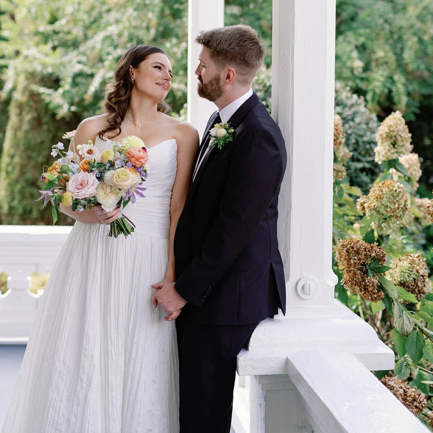 Beth and Peter Boone holding hands on their wedding day.