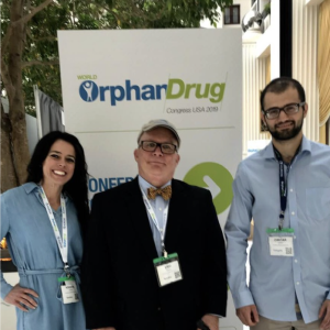 Kristin Schneider Smedley, H. Eric Hartman, and an acquaintance pose together at the World Orphan Drug Congress USA 2019.